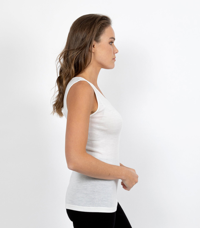 Women's ivory merino wool thermal vest, side profile view on model
