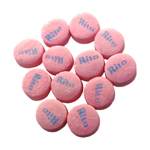 A close-up of multiple pink wintergreen Canada Mints, stamped with the word “Rito,” showcasing their smooth, classic lozenge shape.