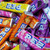 Mixed assortment of PEZ fruit candy refill packs in colorful wrappers, variety of classic flavors for PEZ dispensers.
