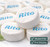 Close-up view of Canada Mints Peppermint Lozenges featuring the distinctive “Rito” imprint and smooth white lozenge texture. Gluten-free wintergreen mints with a refreshing flavor.