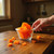 Sweetened sun-dried papaya chunks in a glass bowl on a kitchen counter, illustrating size, cut, and serving presentation.