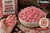 Handful and bowl of Claey's Sanded Cinnamon Drops showcasing candy size and generous bulk quantity. Approximately 180 pieces per 2 lb bag, perfect for candy dishes, offices, parties, sharing, and everyday enjoyment.