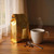 Gold coffee bag next to a steaming white coffee cup.
 Medium roast coffee packaged in a gold bag, served with a fresh hot cup – perfect for home brewing and gifting.