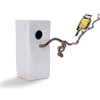 MENSCHMADE "Bird's Palace" ceramic bird house resembling a Tetra milk pack and a hazelnut twig as bird seat and a blue tit