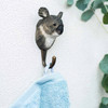 Hand-carved Koala wall hook carrying a towel, mounted on white wall.
