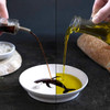 Somebody pores oil into the Peleg Design Dip Sea Oil And Vinegar Dipping Dish