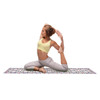 Woman holding a yoga pose (pigeon pose) on the full DOIY Barcelona tile pattern mat against a white background.