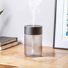 Lifestyle shot of the Lexon Horizon Humidifier on a modern desk, emitting a fine, cool mist into the air for aromatherapy.
