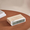 Pantone Sand Dollar alarm clock with flip on/off design on table