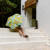 Woman with BLUNT umbrella in Daffodil design sitting on steps