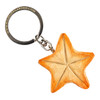 The underside of the hand-carved wooden Starfish keyring, showing the engraved texture and key ring.