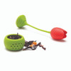 Open OTOTO Tulip silicone tea infuser base filled with loose tea leaves next to the red flower stem.