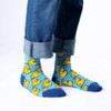 Person wearing SEXY SOCKS Rubber Duck bamboo socks paired with cuffed blue jeans.