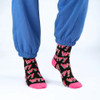 Person wearing SEXY SOCKS WTF bamboo socks paired with casual blue trackpants.