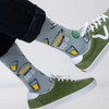Outdoor action shot of a person wearing SEXY SOCKS Tequila Made Me Do It bamboo socks paired with green suede sneakers.