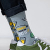 Close-up of a person wearing SEXY SOCKS Tequila Made Me Do It bamboo socks with green sneakers.