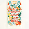 Close-up view of Blue Q My Favorite Salad Is Wine tea towel showing the illustrated phrase on unbleached cotton.