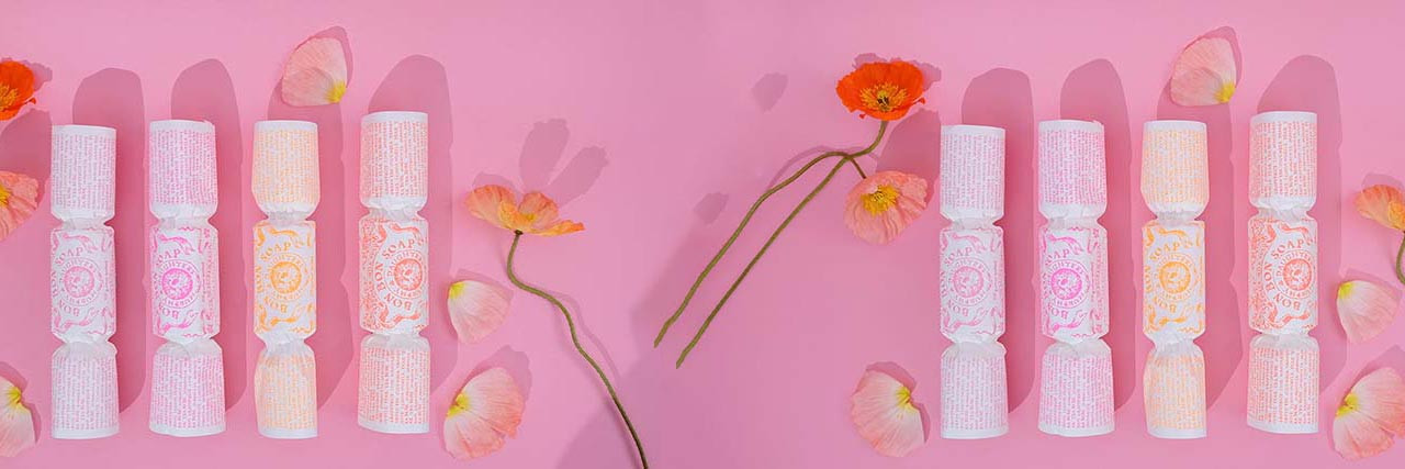 Four bonbon soaps on pink surface