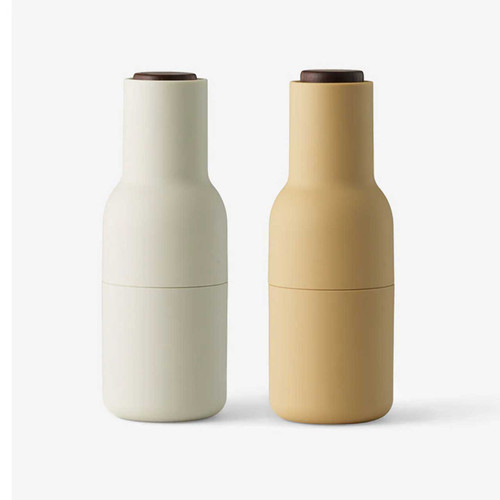 Front view of AUDO (ex-Menu) Bottle Grinder pair in Barley with walnut tops on a white background.