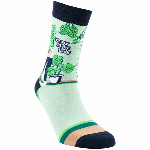 SEXY SOCKS Crazy Plant Lady bamboo sock featuring a woman holding a large fiddle-leaf fig surrounded by monstera and snake plants.