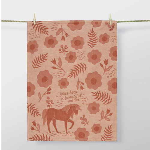 Blue Q Your Home Is Beautiful Ma'am woven cotton dish towel hanging from wooden pegs on a clothesline, showcasing the full floral and horse jacquard design.