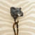 Three-quarter view of a wall-mounted Elephant wall hook holding a timber beads necklace.