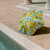 BLUNT Metro umbrella Daffodil beside pool