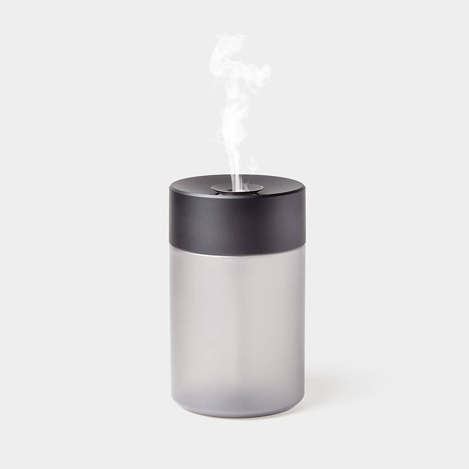 Front view of the Lexon Horizon Aromatherapy Humidifier in gunmetal, featuring a cylindrical aluminium design with a minimalist top nozzle.