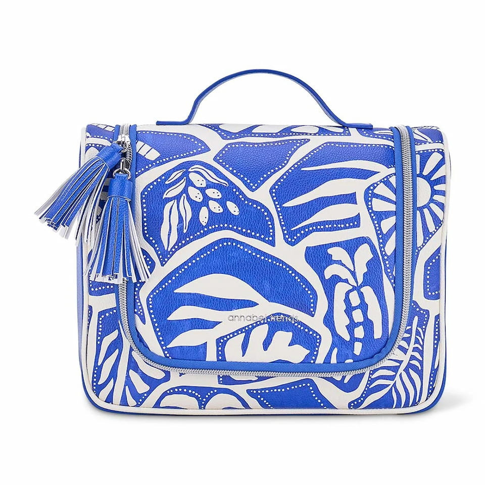 Annabel Trends Blue Oasis Vanity Overnight Bag featuring structured faux leather with a cobalt blue mosaic print, top carry handle, and decorative tassel zippers.