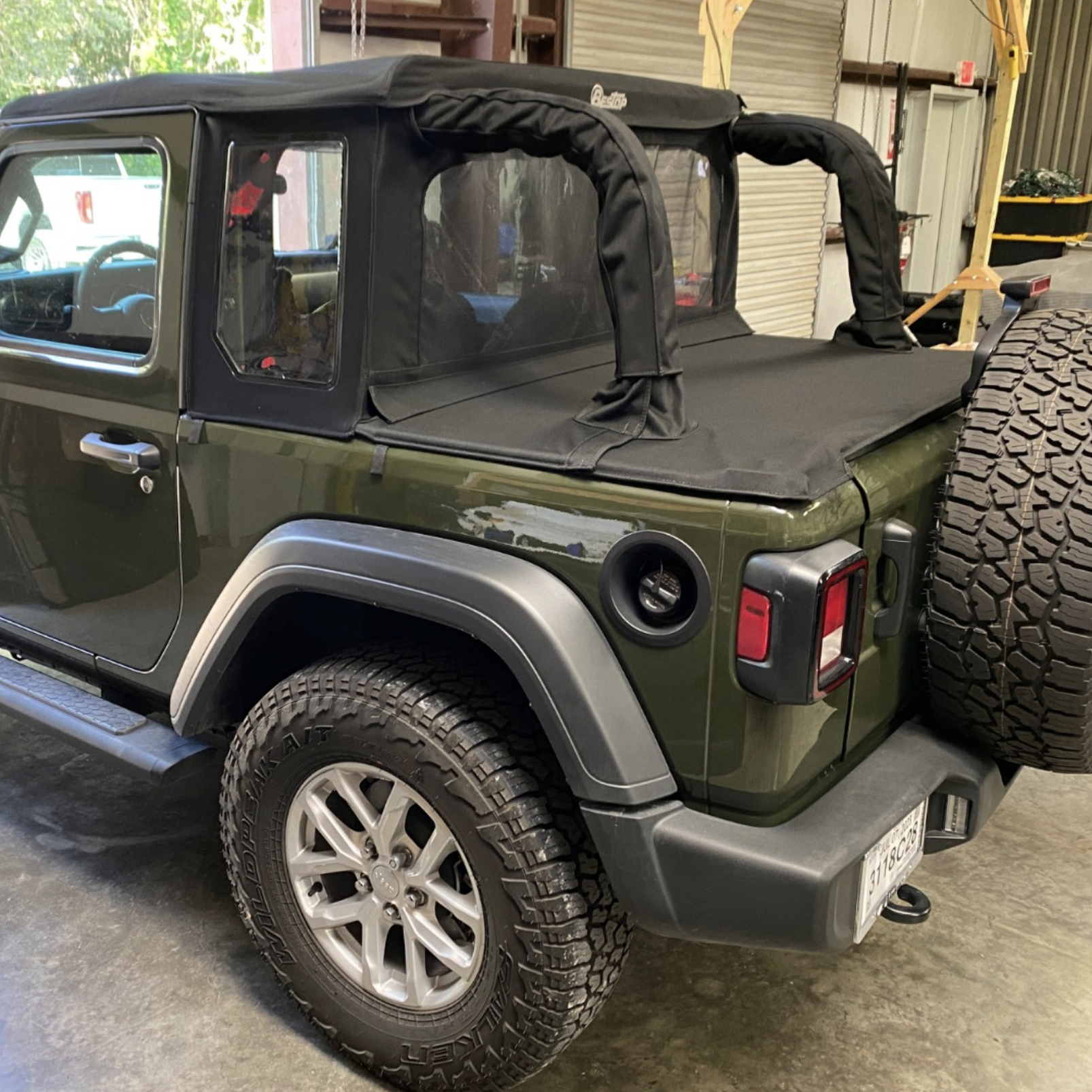 #green jeep with soft top and accessories at top swap texas