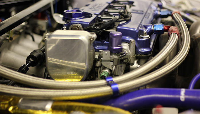 PTFE braided fuel hose and AN fittings being prepared for a custom fuel system