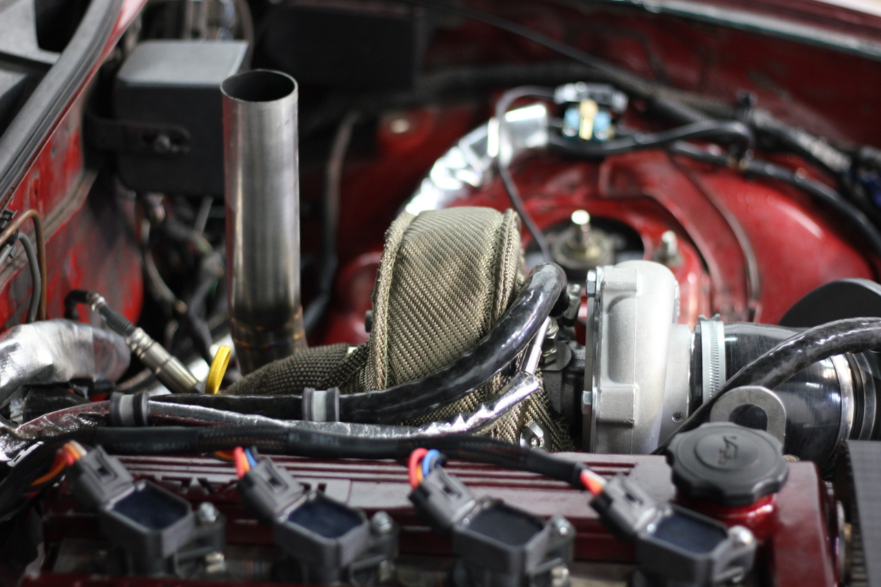 Turbo MX-5 engine bay showing the tight turbo and downpipe packaging near the rear of the bay