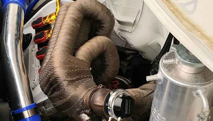 Exhaust wrap fitted to hot pipework to reduce radiant exhaust heat in a modified car