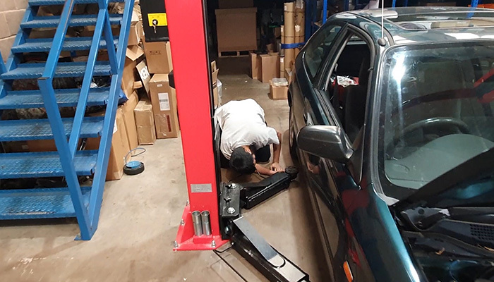Honda Civic being lifted before silicone hose kit installation