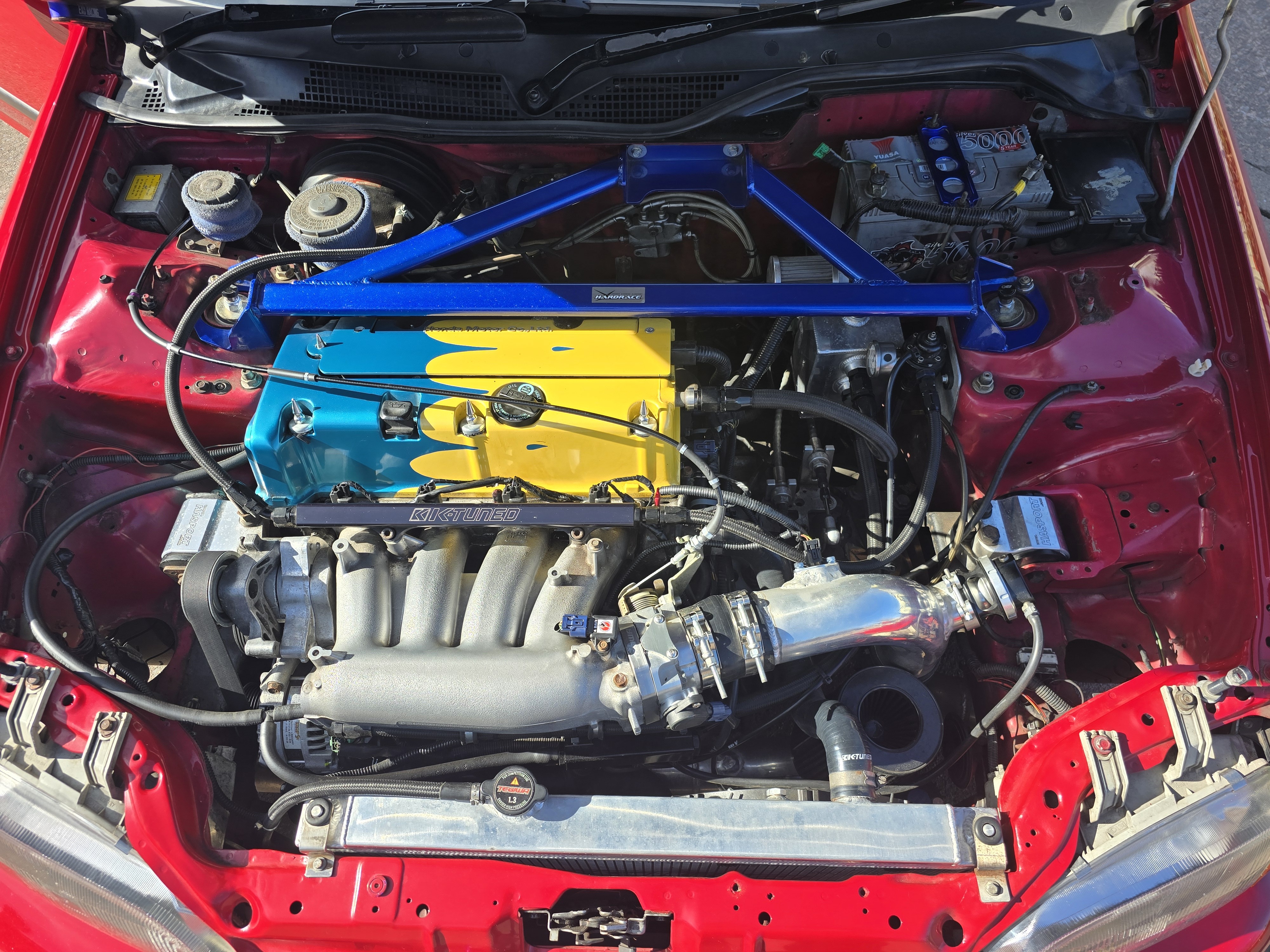 Catch can and breather line installation example in a modified engine bay