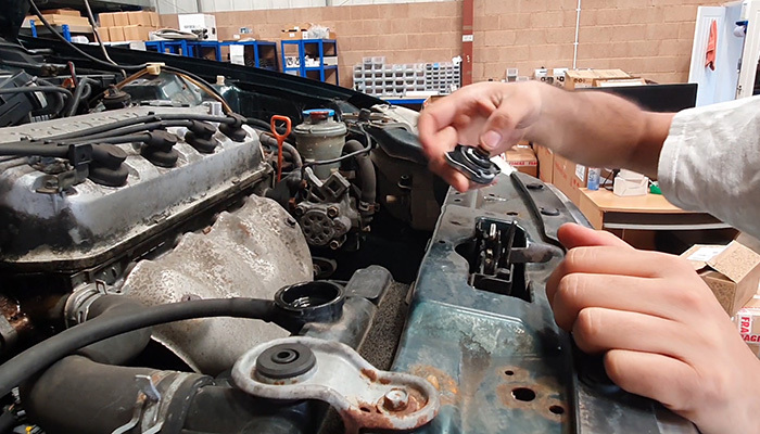 Radiator cap removed before coolant hose replacement