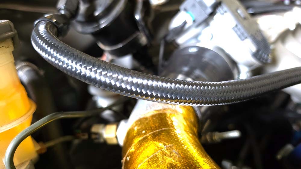 Braided fuel line and fittings in a modified AWD Civic engine bay