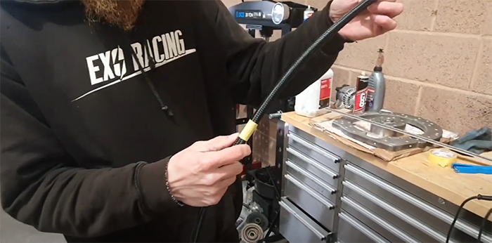 Masking tape wrapped around braided PTFE hose to stop the braid fraying