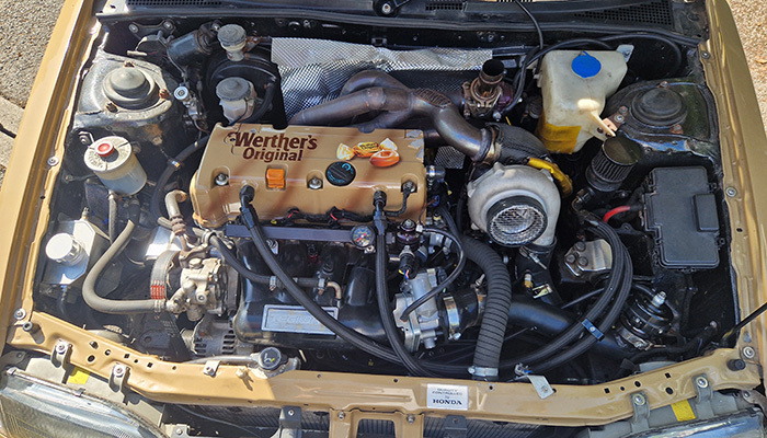 K24 turbo Honda Concerto engine bay with reflective firewall heat management behind the turbo area