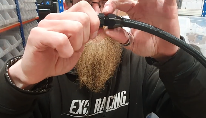 Finished AN PTFE hose end assembled onto braided PTFE hose