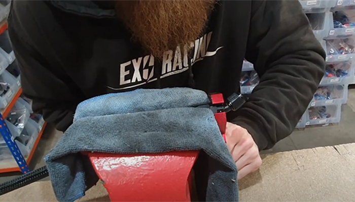 Tightening a rubber braided hose AN fitting in the vice with an AN spanner