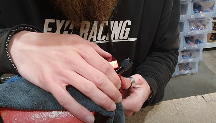 AN PTFE fitting held in a vice ready to tighten