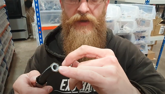 Positioning the PTFE fitting olive between the PTFE liner and outer braid