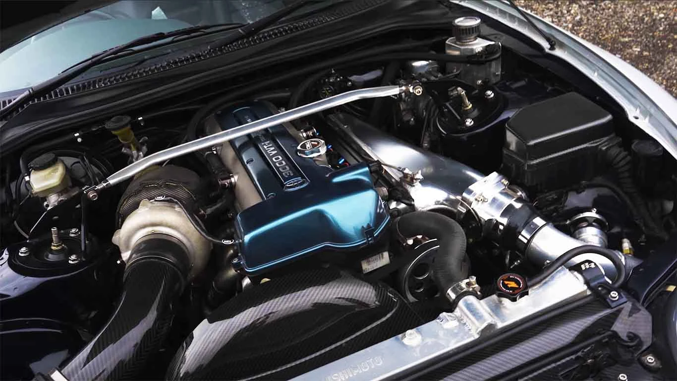 Toyota Supra engine bay showing exhaust heat management around a turbo setup