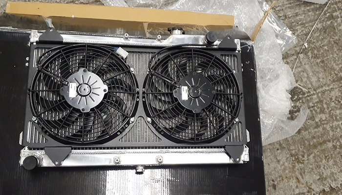 Fan shroud being fitted to a radiator to improve airflow through the engine bay cooling system
