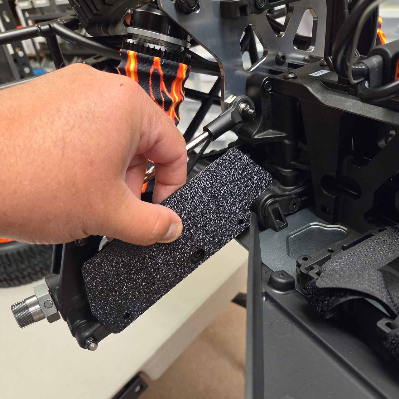 We do recommend removing the A-arms to do the drilling but you can position and mark the holes while they are on the truck.