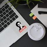 gosh sticker on laptop next to coffee and desk setup