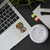 Funny sarcastic sticker with rope duct tape and shovel design applied to laptop next to coffee and office desk items