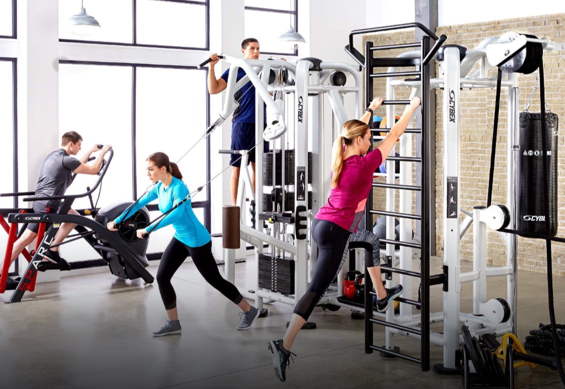 People are working out in a gym with cybex equipment - image