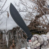 KA-BAR 1248 CUTLASS MACHETE. 11.0" SK5 BLADE. TPR HANDLE. LEATHER/CORDURA SHEATH. SHOWN IN HAND. CUTLERY SHOPPE